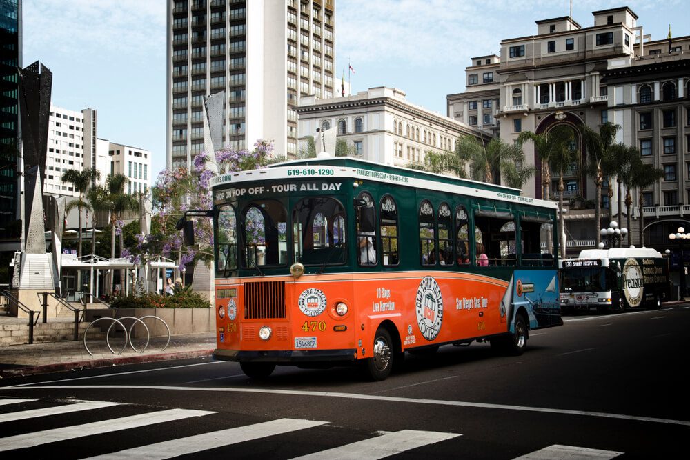 San Diego bus tour_San Diego, California / United States - July 7, 2019: Image of a San touring trolly in the famous Gaslamp District in San Diego, California.