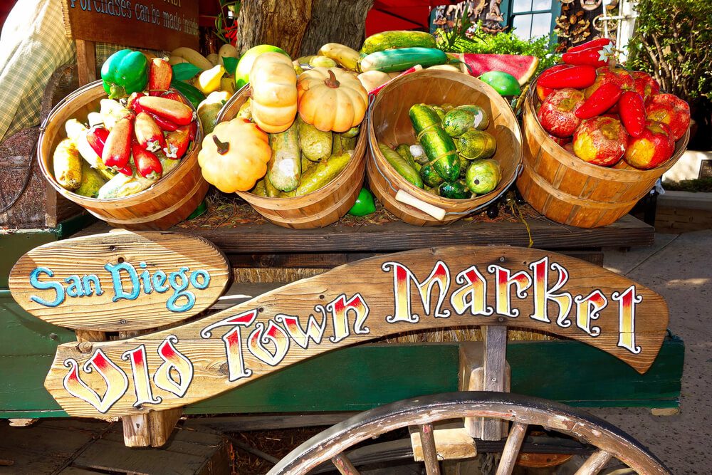 vineyard market_A closeup shot of vegetables in wooden pots above the "San Diego Old Town Market" sign