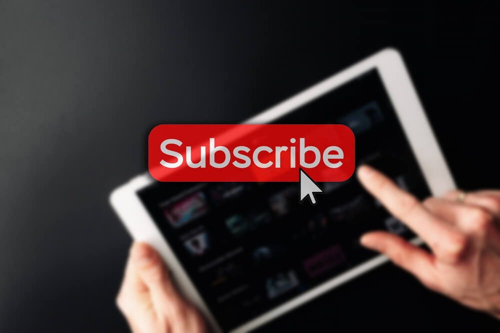 subscription_Subscription plan. Red online video subscribe button. Internet service on laptop digital tablet blured technology background. Visual contents concept. Social networking service