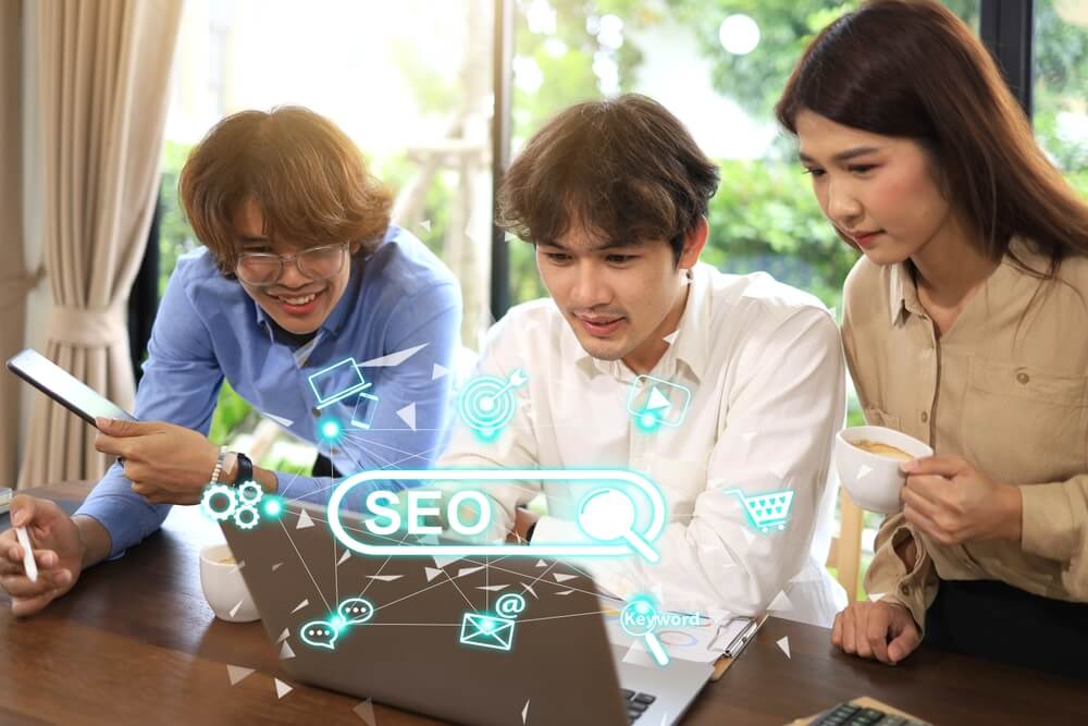 technical seo_Three people using SEO or Search Engine Optimization is the process used to optimize a website's technical configuration, content relevance, and link popularity so its pages can become easier.