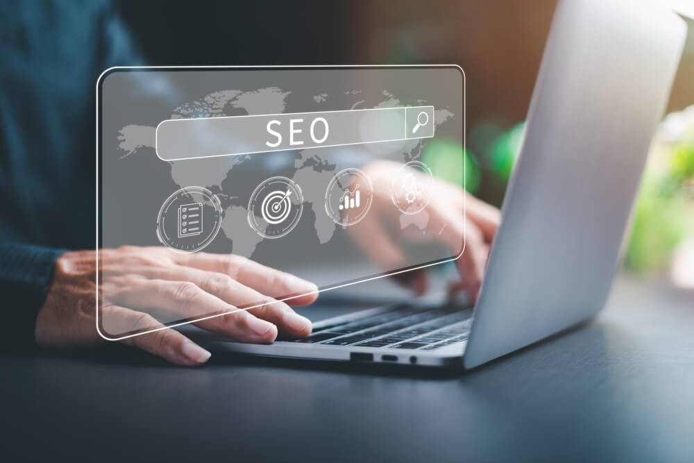 keywords_Marketers use laptops to analyze SEO, optimization analytics tools concepts. search engine ranking Social media sites based on results analytics data, effective keyword selection.