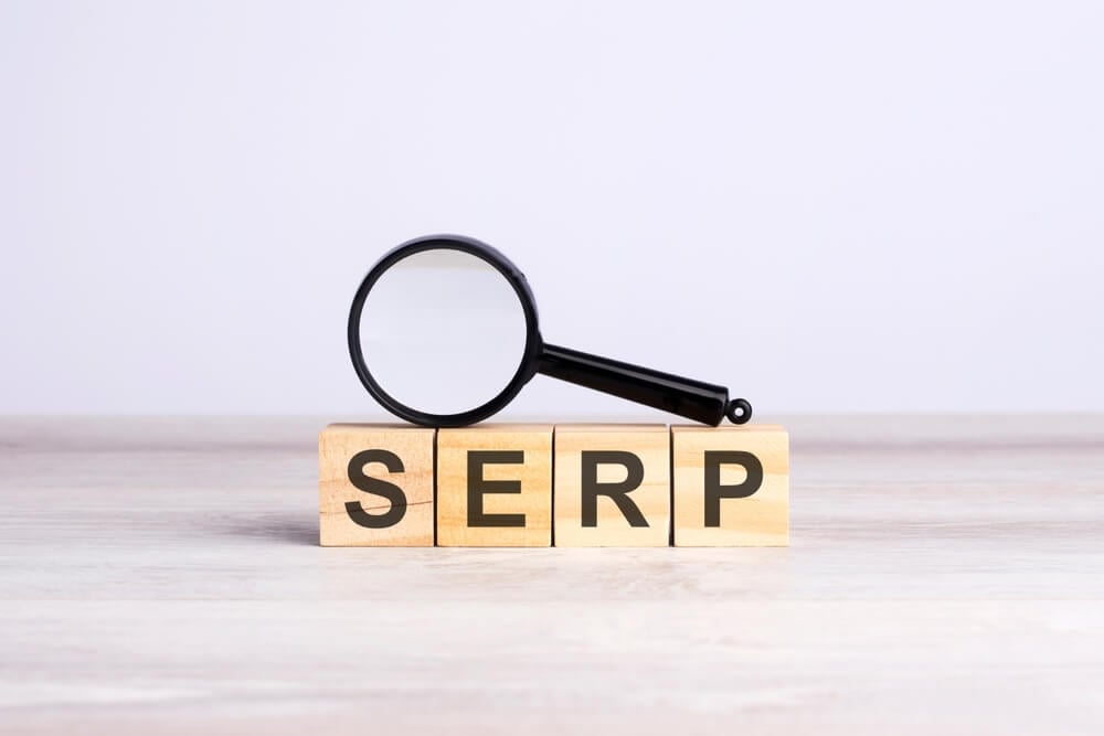 SERP_magnifying glass and wooden blocks with the text: SERP. can be used for business, marketing and education concept