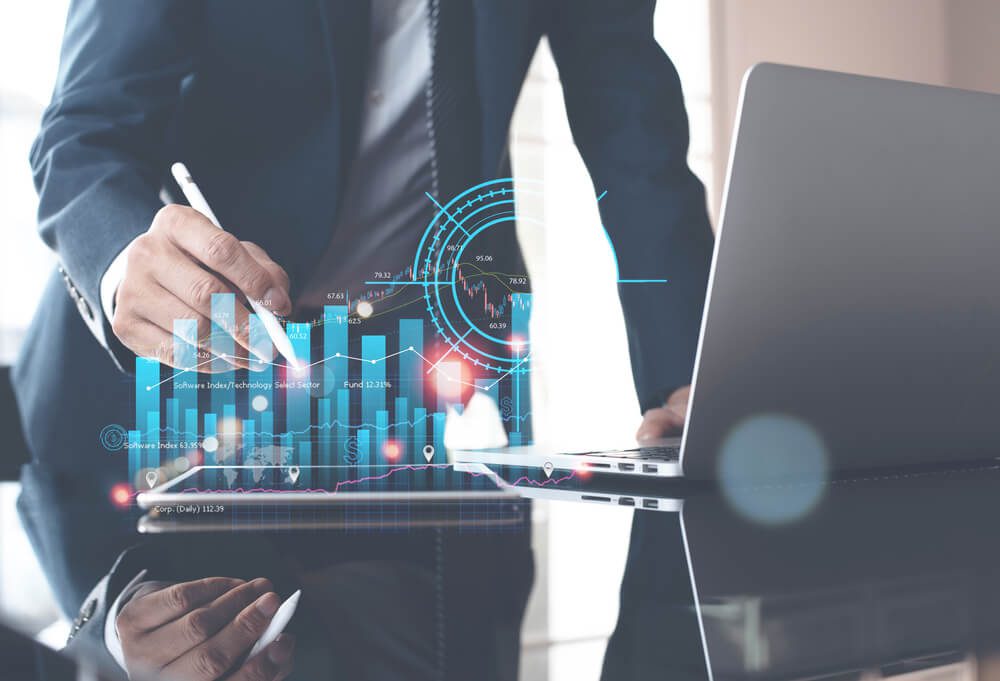 digital strategy__Businessman analyzing financial data on laptop computer and digital tablet with financial graph growth chart on virtual screen, business planning, strategy, digital marketing report and technology