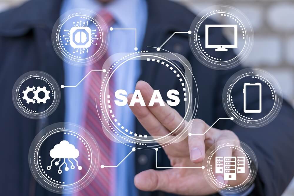 SaaS SEO_Businessman using virtual touchscreen presses abbreviation: SAAS. Software As A Service (SAAS) Concept.