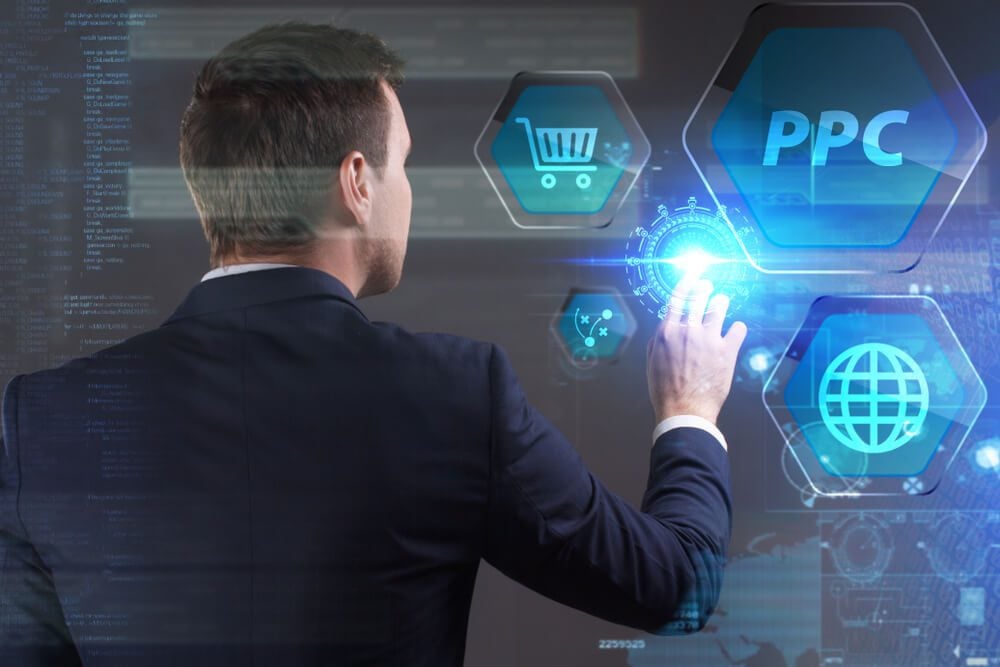 ppc_Business, Technology, Internet and network concept. Young businessman working on a virtual screen of the future and sees the inscription: PPC
