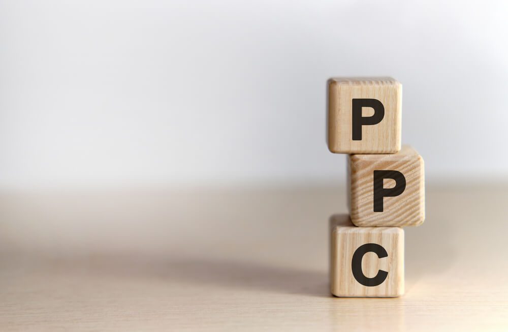 ppc roi_PPC pay per click - concept on vertical wooden cubes