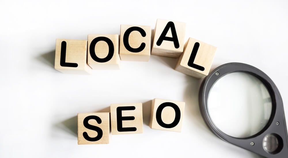 local seo_LOCAL SEO text on wood block with magnifier, business concept