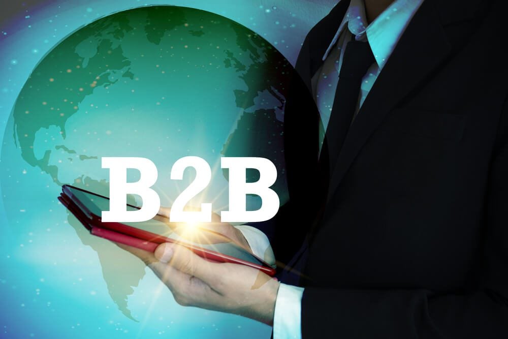 b2b mobile app_businessman with tablet and B2B text ,world connection concept, business concept , business idea