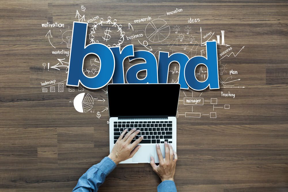 digital brand_Brand identity ideas concept, Creative thinking drawing charts and graphs strategy plan on wooden table background, Inspiration concept with businessman working on laptop computer PC, Top View