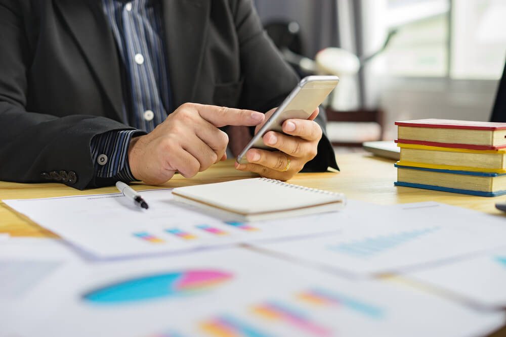 Cost vs Benefit of Mobile App Development for Your Business 3 seo and app store_Online banking payment communication network technology internet wireless tools development mobile smartphone sync app: Business woman holding smart phone for online or shopping payment,vintage color