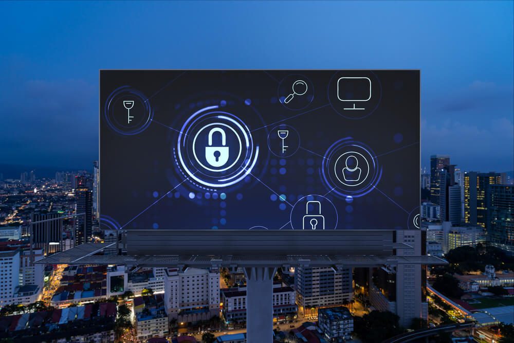 custom software security_Padlock icon hologram on road billboard over panorama city view of Kuala Lumpur at night to protect business, Malaysia, Asia. The concept of information security shields.