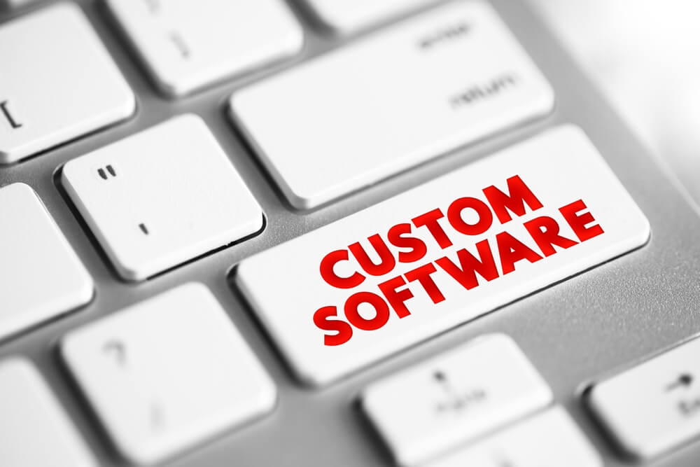 custom software development_Custom Software is software that is specially developed for some specific organization or other user, text concept button on keyboard