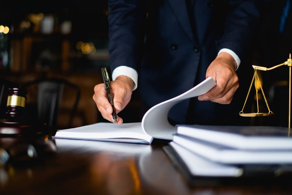 lawyer_Close up lawyer businessman working or reading lawbook in office workplace for consultant lawyer concept.