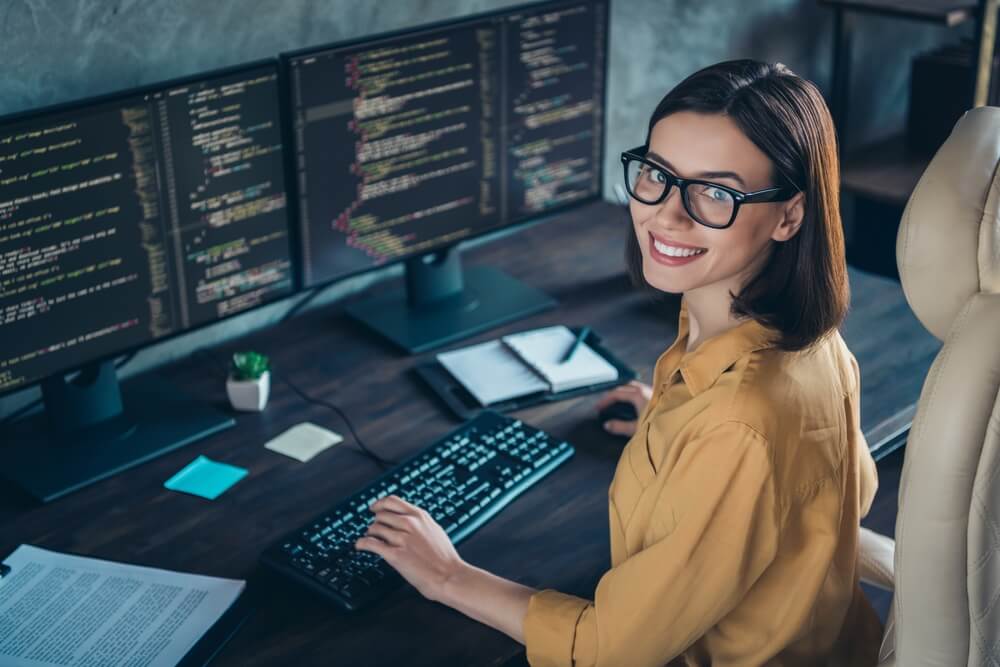 custom software development_Profile side view portrait of attractive cheerful skilled girl geek developing web site cyber security at workplace workstation indoors