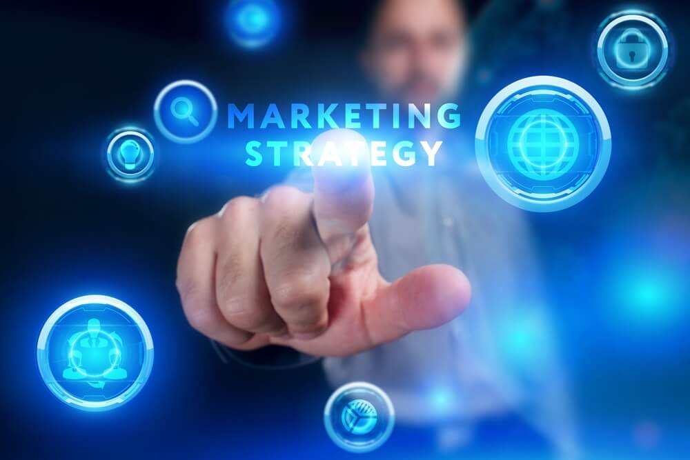 marketing strategy_Business, Technology, Internet and network concept. Young businessman working on a virtual screen of the future and sees the inscription: Marketing strategy