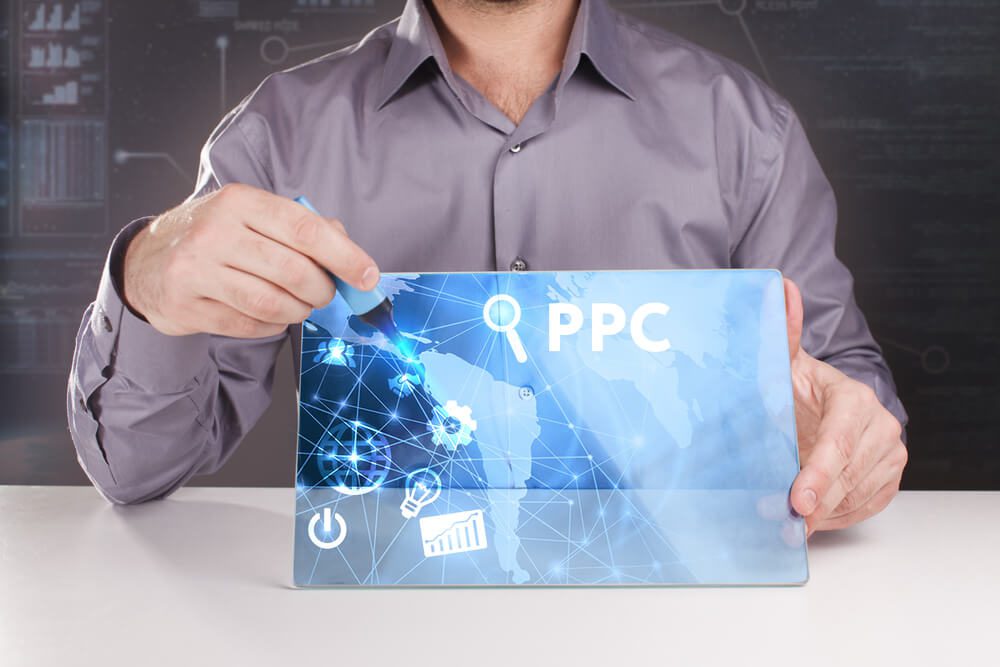 ppc_Business, Technology, Internet and network concept. Young businessman working on a virtual screen of the future and sees the inscription: PPC