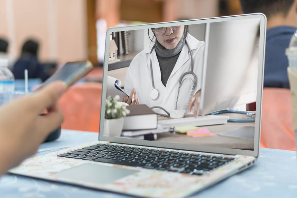 healthcare content_Asian Female Medicine doctor working Telemedicine give consultation video chat to auditorium distance learning presentation in conference meeting room for teaching workshop traning technology content