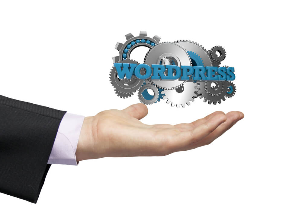 wordpress_gears with the text wordpress over a businessman hand