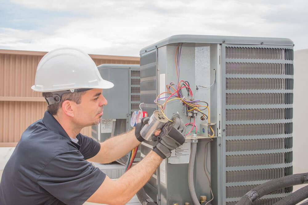 HVAC_HVAC technician working on a capacitor part for condensing unit.