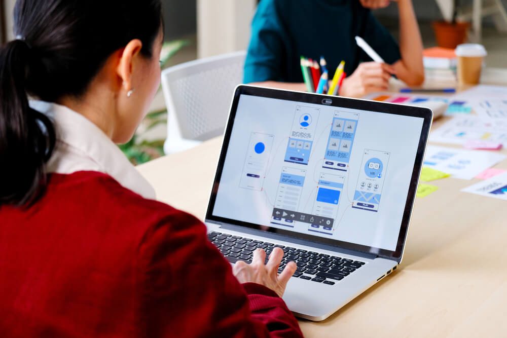 9 Common UX Design Fails and How You Can Avoid Them 1 user experience_Website designer, Creative planning phone app development template layout framework wireframe design, User experience concept, Young asian woman UX designer working on smartphone application at office