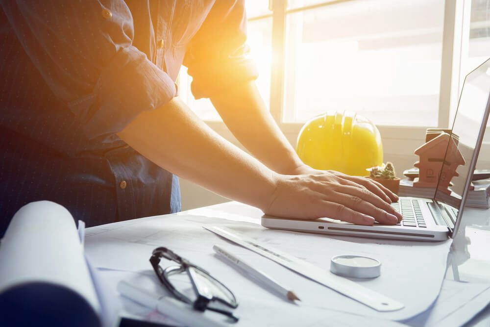 building contractors_architect man working with laptop and blueprints,engineer inspection in workplace for architectural plan,sketching a construction project ,selective focus,Business concept vintage color