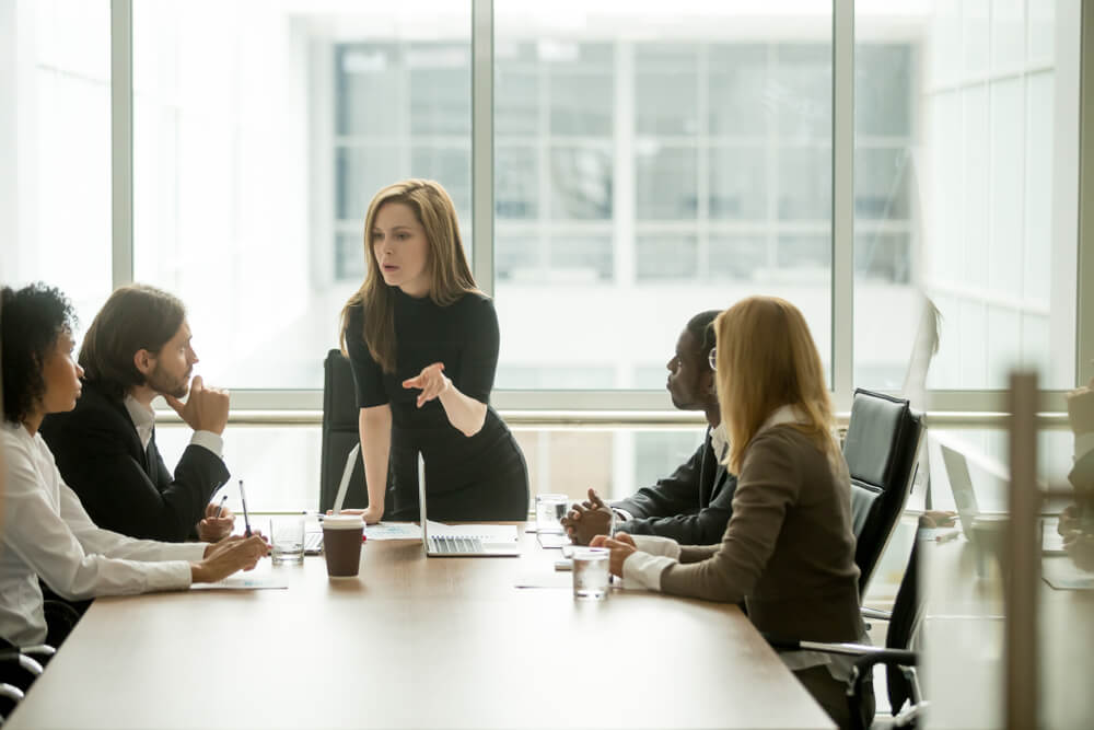 marketing director_Serious woman boss scolding employees for bad results or discussing important instructions at multiracial team meeting, dissatisfied female executive talking to multiracial team at boardroom