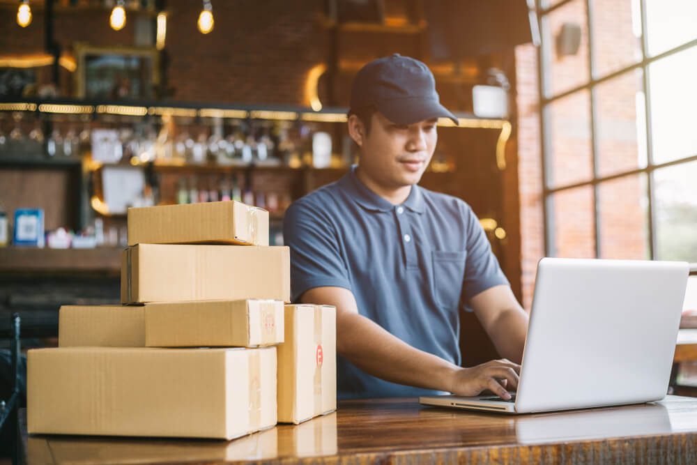 ecommerce_Online shopping young start small business in a cardboard box at work. The seller prepares the delivery box for the customer, online sales, or ecommerce.