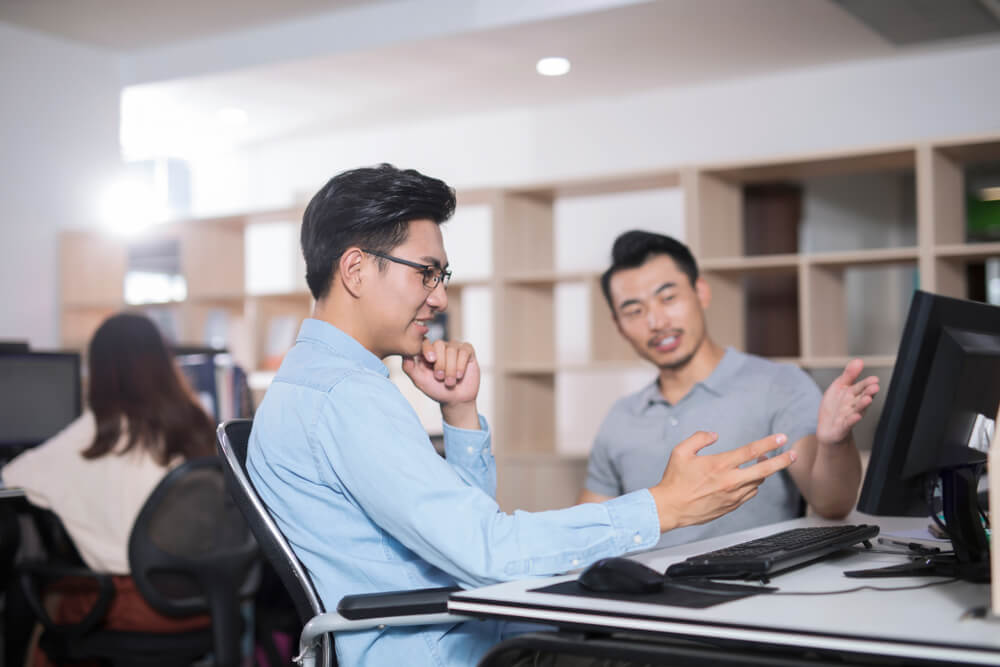 ecommerce team_Two businessman discussing in office.