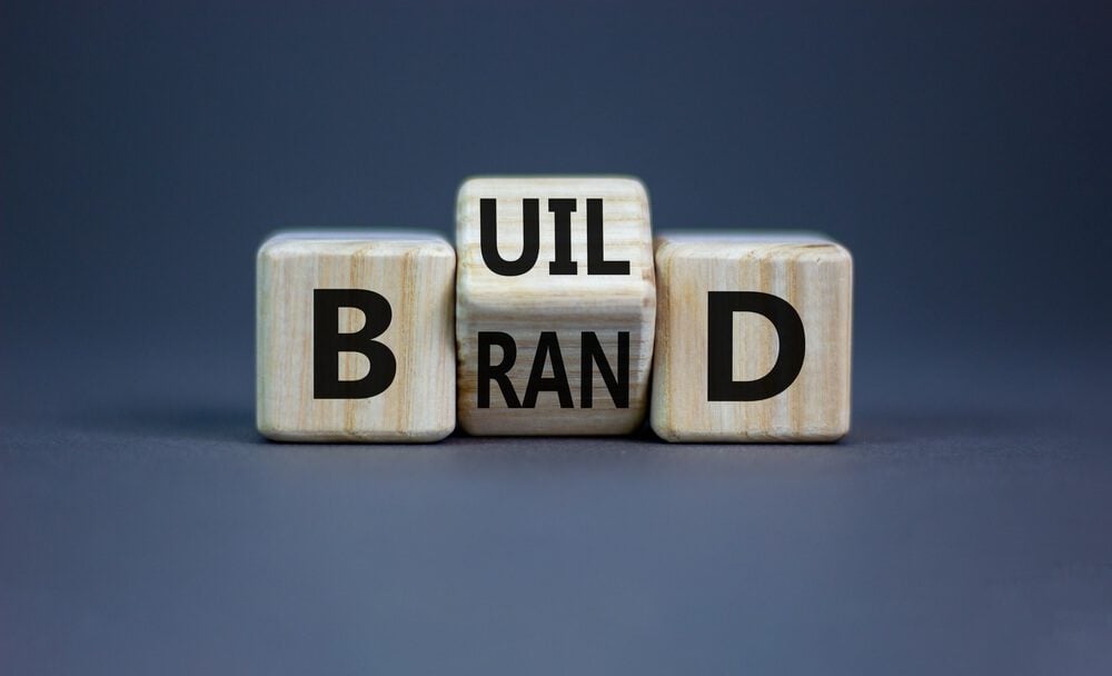 brand_Build your brand symbol. Turned wooden cubes and changed the word 'build' to 'brand'. Beautiful grey background. Build your brand and business concept. Copy space.