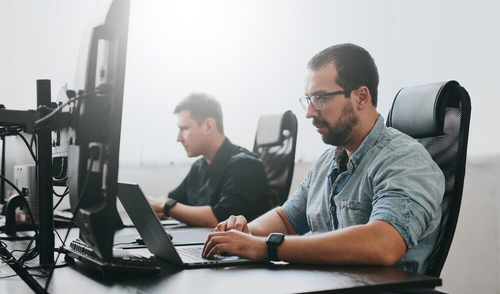 technical seo_Portrait of two professional male programmers working on computer in diverse offices. Modern IT technologies, development of artificial intelligence, programs, applications and video games concept