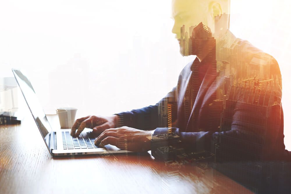 marketing director_Double exposure of man trader dressed in corporate suit is analyzing financial market via laptop computer. Skilled businessman keyboarding e-mail letter while using net-book. High technology concept