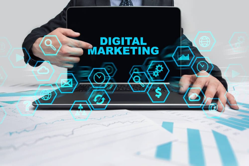 digital marketing_Businessman pointing on notebook screen and selecting Digital Marketing.