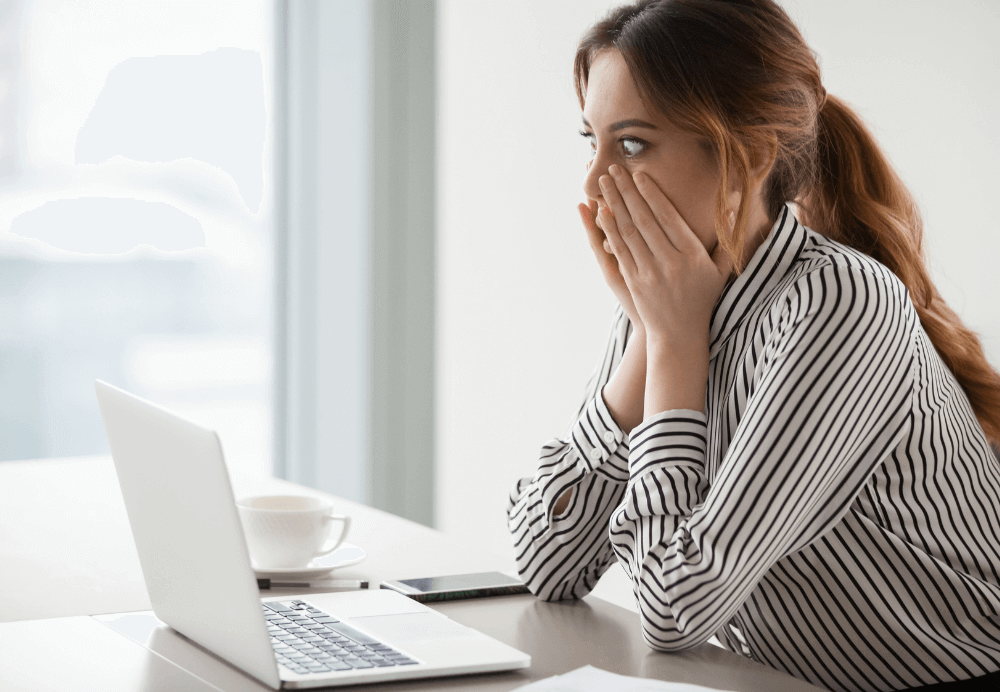 content marketing mistake_Shocked woman worker looking at laptop screen surprised with bad or unexpected online news, amazed businesswoman feel despair rounding eyes witnessing company bankruptcy or market failure