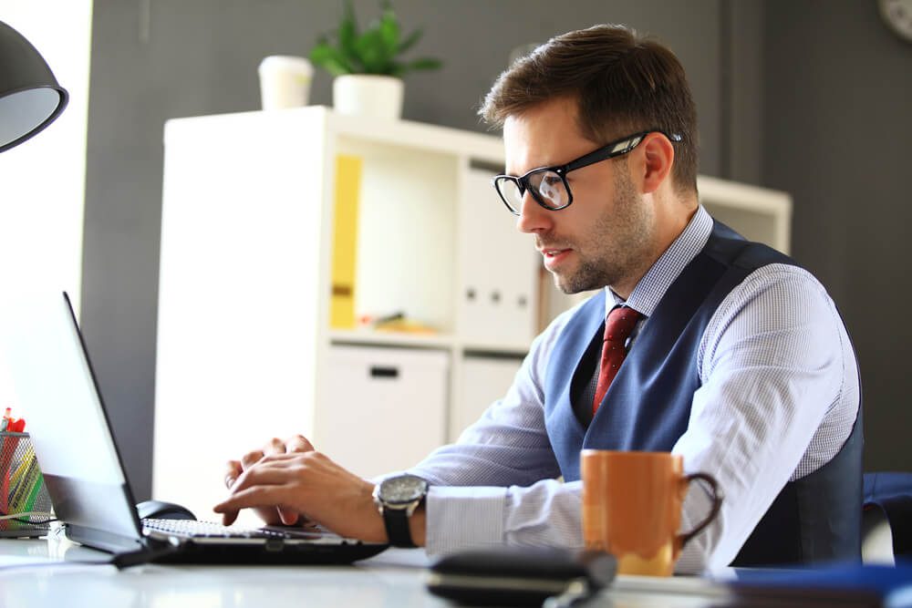 FCMO_Handsome businessman working with laptop in office