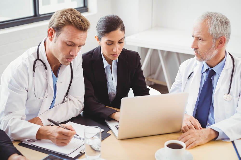 healthcare_Medical team using laptop in conference room in hospital