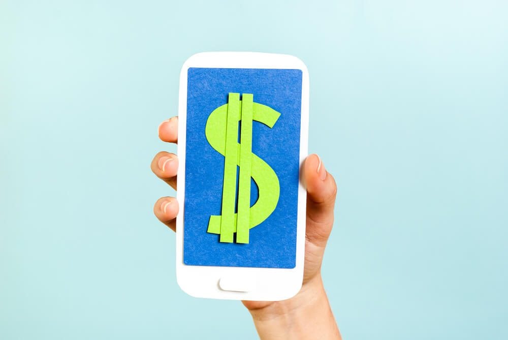 budget for content_Green dollar money sign symbol mobile phone, smartphone, on blue background.