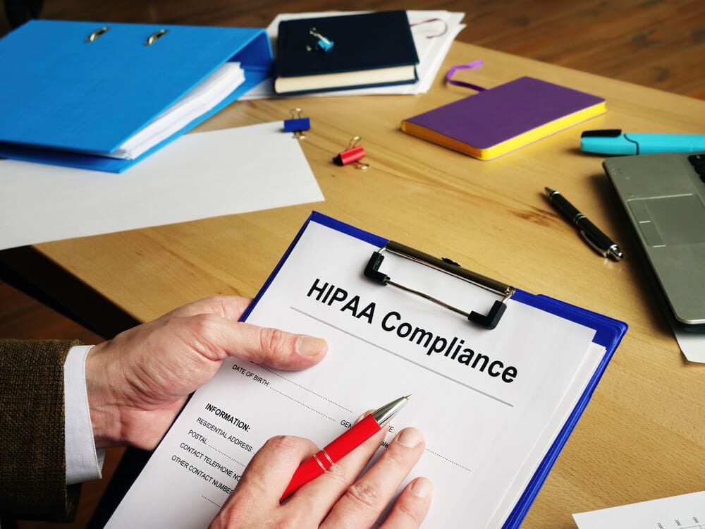 HIPAA compliance_Clerk reads documents about HIPAA Compliance.