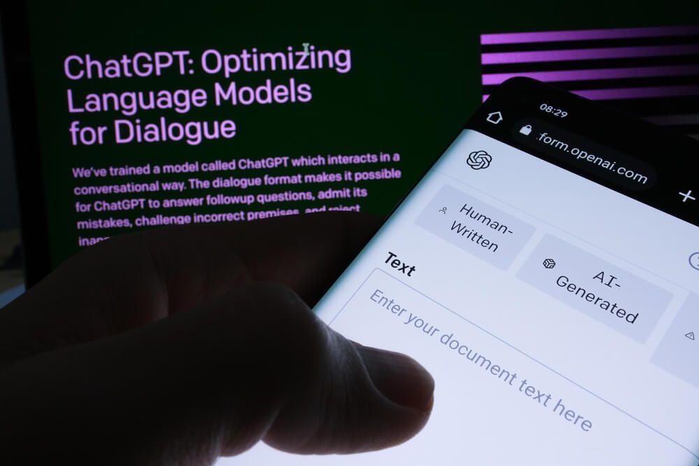 chatGPT_Ai Text Classifier software webpage seen on smartphone screen and ChatGPT page on the blurred background. Tool for AI written text detection by OPEN AI. Stafford, United Kingdom, February 2, 2023
