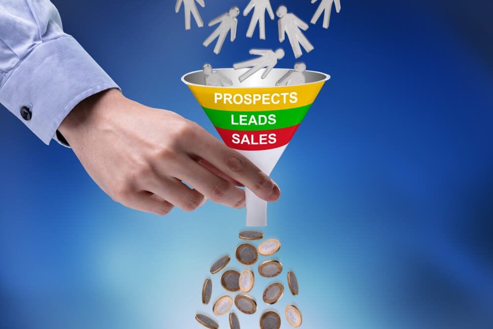leads funnel_Close-up Of Businessman Holding Funnel Converting Prospects Into Money