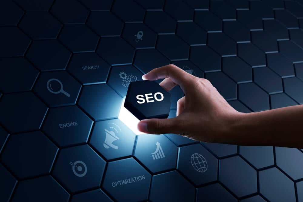 SEO_Hand of human putting hexagon piece to full fill the part of SEO Search Engine Optimization. Digital marketing process, Strategy, Business Technology concept.