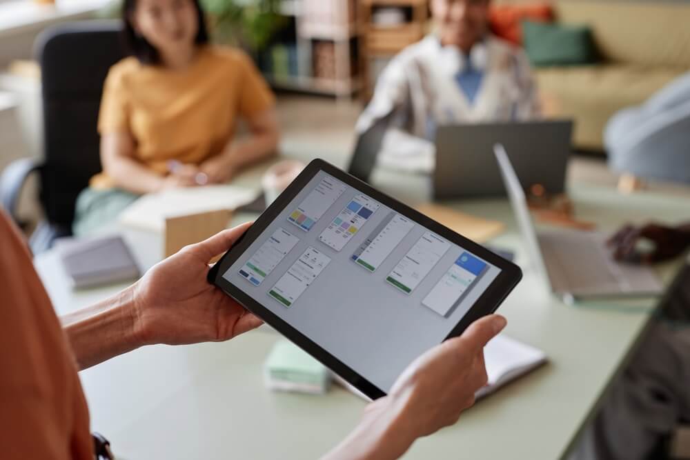 technical UX_Close up of young businesswoman holding tablet with UX UI designs for mobile app, copy space