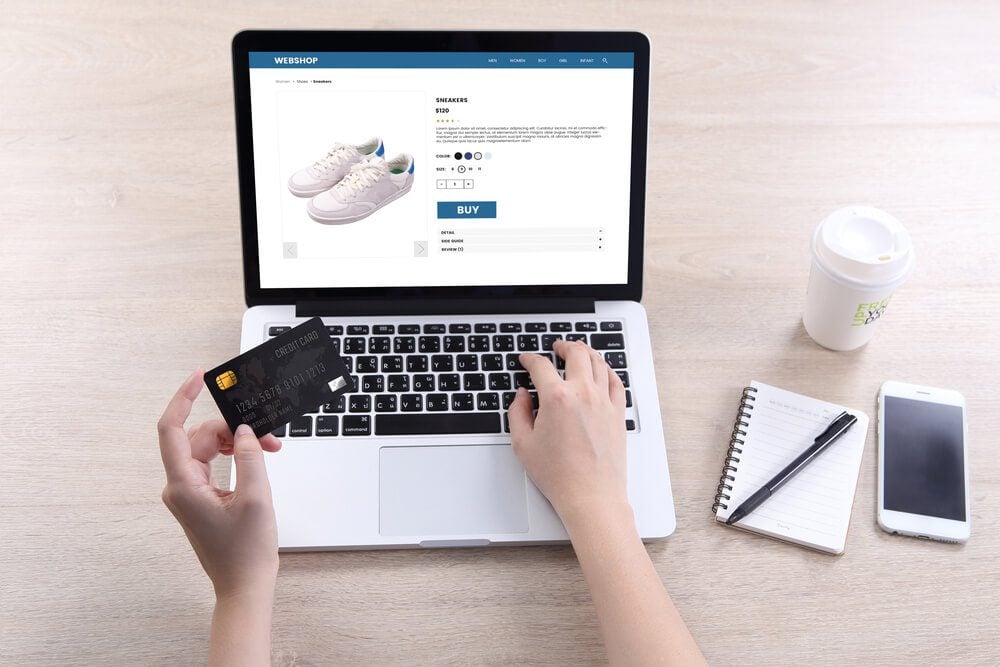 eCommerce_Woman use ecommerce webshop for buy shoes with holding credit card