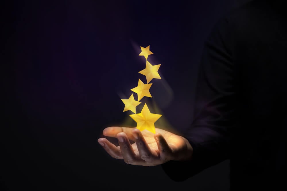 customer success_Success in Business or Personal Talent Concept. Gesture Hand with Golden Five Star Awards