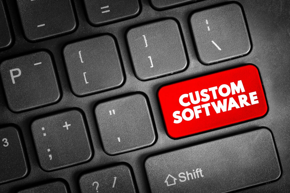 custom software development_Custom Software is software that is specially developed for some specific organization or other user, text concept button on keyboard