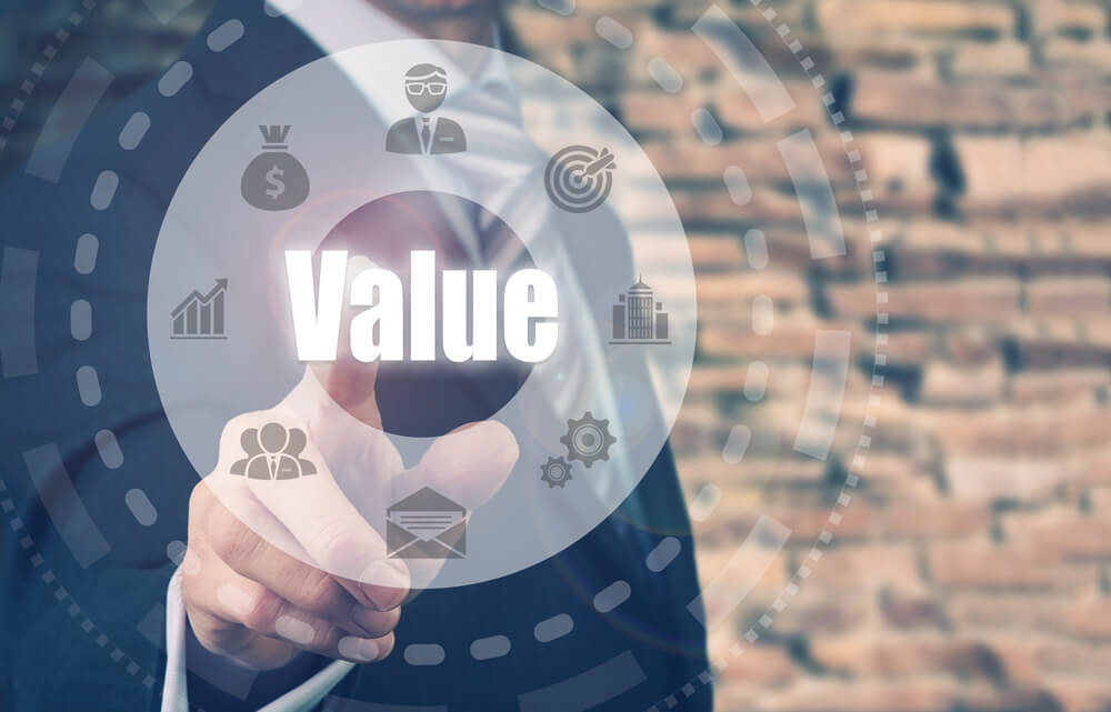 value creation_Businessman pressing a Value concept button.