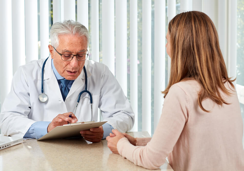 patients_Elderly doctor man with patient woman.