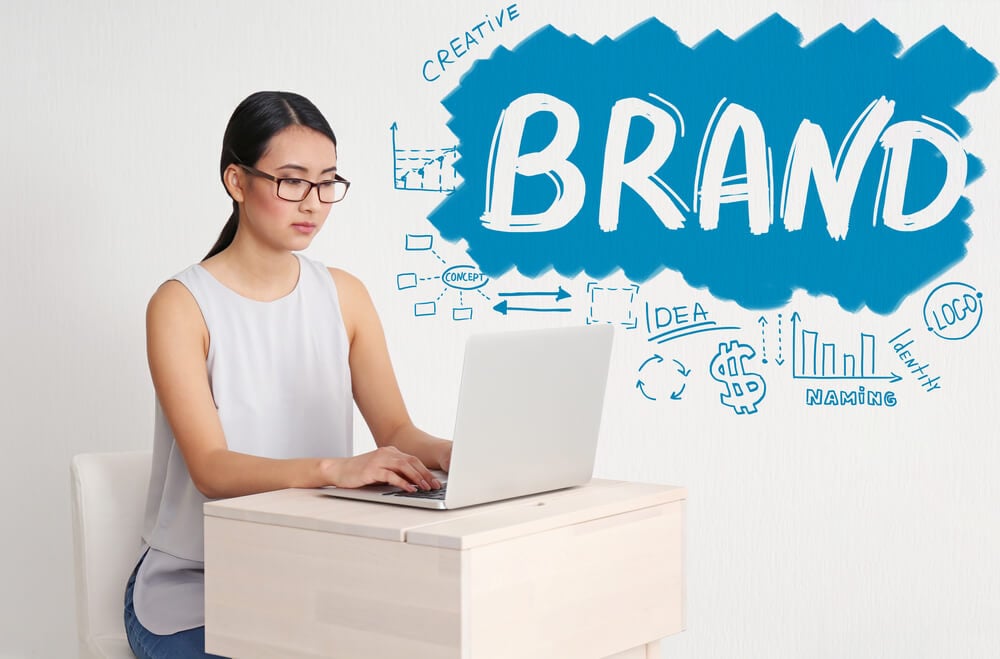 brand management_Brand marketing concept. Young woman working with laptop in office