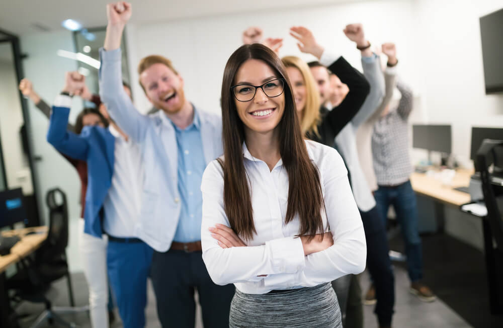 employees_Happy business people celebrating success at company