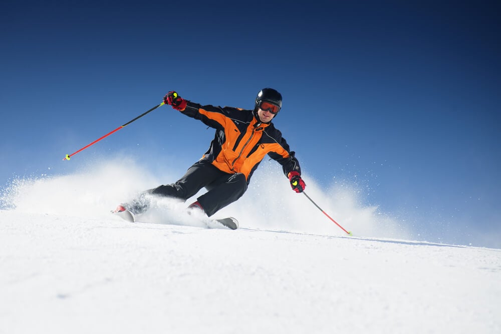 Ski Resort_Skier in mountains, prepared piste and sunny day