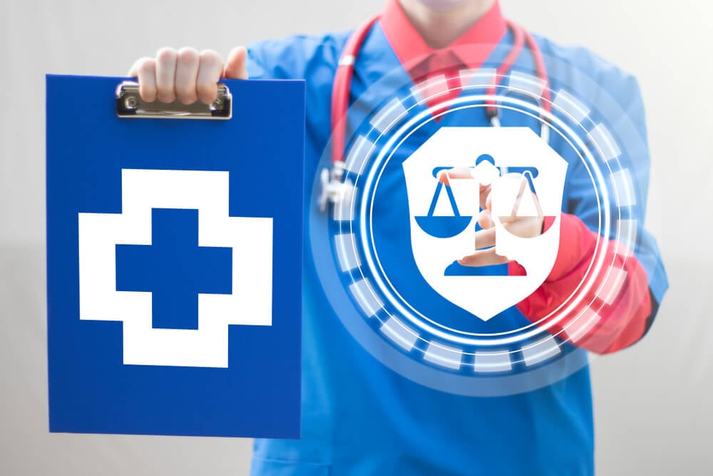 HIPAA-compliant_Pharmacy Compliance Medicine concept. Doctor holds blue clipboard with medical cross and push shield balance button.